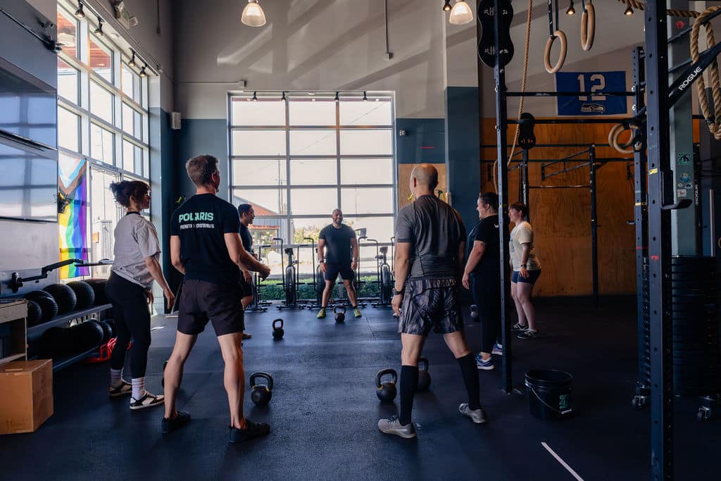 group class practicing with kettlebells